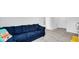 Comfortable living area with plush blue sectional sofa and soft carpet at 4763 W Tradwell Dr, New Palestine, IN 46163