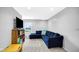 Inviting living space featuring a comfortable blue sofa, storage shelving, and stylish carpet at 4763 W Tradwell Dr, New Palestine, IN 46163