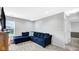 Cozy living area with plush blue sectional sofa and soft carpet at 4763 W Tradwell Dr, New Palestine, IN 46163