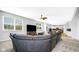 Bright living room featuring an open layout, comfortable seating, and views of the dining and kitchen areas at 4763 W Tradwell Dr, New Palestine, IN 46163