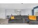 Spacious living room features a large sectional couch, carpeted floors, a staircase, and modern decor at 4763 W Tradwell Dr, New Palestine, IN 46163