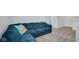 Comfortable living room features neutral carpeting and a comfortable blue sectional sofa at 4763 W Tradwell Dr, New Palestine, IN 46163