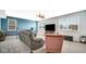 Bright living room featuring a comfortable couch and large windows that provide lots of natural light at 4763 W Tradwell Dr, New Palestine, IN 46163