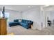 Cozy living room features neutral carpeting, recessed lighting, and comfortable blue sectional sofa at 4763 W Tradwell Dr, New Palestine, IN 46163