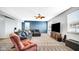 Inviting living room with comfortable seating and a wall-mounted TV, perfect for entertaining guests at 4763 W Tradwell Dr, New Palestine, IN 46163