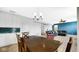 Bright living room featuring a modern chandelier and open layout, adjacent to the kitchen area at 4763 W Tradwell Dr, New Palestine, IN 46163
