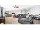 Comfortable living room with plush gray sofas, recessed lighting, and an open layout to the kitchen and dining area at 4763 W Tradwell Dr, New Palestine, IN 46163