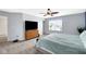 Comfortable main bedroom features modern dresser, large window, and ceiling fan at 4763 W Tradwell Dr, New Palestine, IN 46163
