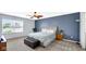 Comfortable main bedroom with large window, ceiling fan, and accent wall at 4763 W Tradwell Dr, New Palestine, IN 46163