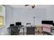 Home office features a modern desk, a comfortable chair, neutral walls, and natural light from the window at 4763 W Tradwell Dr, New Palestine, IN 46163