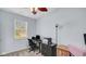 Home office features a modern desk, a comfortable chair, neutral walls, and natural light from the window at 4763 W Tradwell Dr, New Palestine, IN 46163