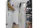 Functional utility room with shelving for storage and modern water heater at 4763 W Tradwell Dr, New Palestine, IN 46163