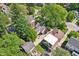 An aerial view of the property surrounded by lush greenery and mature trees in a suburban neighborhood at 5034 N Capitol Ave, Indianapolis, IN 46208