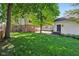 Expansive backyard with lush green grass, mature trees, and a detached garage at 5034 N Capitol Ave, Indianapolis, IN 46208