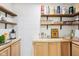 Home wet bar with wood countertops, floating shelves, and ample storage, perfect for entertaining friends and Gathering at 5034 N Capitol Ave, Indianapolis, IN 46208