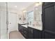Modern bathroom with double vanity, white countertops, and tiled walk-in shower at 5034 N Capitol Ave, Indianapolis, IN 46208