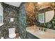 Chic powder room with floral wallpaper, a round mirror, and a marble countertop sink at 5034 N Capitol Ave, Indianapolis, IN 46208