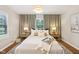 Inviting bedroom with large windows, wood floors, and neutral decor at 5034 N Capitol Ave, Indianapolis, IN 46208