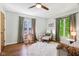 Comfortable bedroom with hardwood floors and a cozy reading chair at 5034 N Capitol Ave, Indianapolis, IN 46208