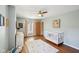 Bright Bedroom with hardwood floors, crib, dresser, and ample natural light at 5034 N Capitol Ave, Indianapolis, IN 46208