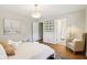 Cozy bedroom with hardwood floors, area rug, and en-suite bathroom with glass shower at 5034 N Capitol Ave, Indianapolis, IN 46208
