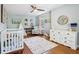 Charming Bedroom with crib, dresser, and cozy reading nook at 5034 N Capitol Ave, Indianapolis, IN 46208