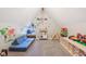 Upstairs bonus room featuring plush carpeting, a comfortable couch, and a creative play area for children at 5034 N Capitol Ave, Indianapolis, IN 46208