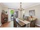 Inviting dining room featuring hardwood floors, a wooden table, and natural light from the sliding glass door at 5034 N Capitol Ave, Indianapolis, IN 46208