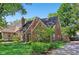 Charming brick home featuring manicured landscaping, a classic chimney, and a quaint, welcoming entrance at 5034 N Capitol Ave, Indianapolis, IN 46208