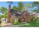Charming brick home featuring manicured landscaping, a classic chimney, and a quaint, welcoming entrance at 5034 N Capitol Ave, Indianapolis, IN 46208