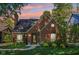 Charming brick home featuring manicured landscaping, a classic chimney, and a quaint, welcoming entrance at 5034 N Capitol Ave, Indianapolis, IN 46208