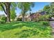 Spacious lawn with mature trees, showcasing a charming brick home with a classic chimney at 5034 N Capitol Ave, Indianapolis, IN 46208