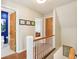 Upstairs hallway with hardwood floors and access to multiple rooms at 5034 N Capitol Ave, Indianapolis, IN 46208