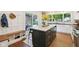 Modern kitchen island featuring a marble countertop, dark cabinetry, and seating for guests at 5034 N Capitol Ave, Indianapolis, IN 46208