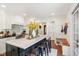 Updated kitchen featuring a center island with seating, white cabinets, and stainless steel appliances at 5034 N Capitol Ave, Indianapolis, IN 46208