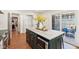 Spacious kitchen island featuring marble countertop, dark cabinetry, and stainless steel appliances at 5034 N Capitol Ave, Indianapolis, IN 46208