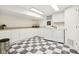 Well-lit laundry room with checkered floors, white cabinets, and modern washer and dryer at 5034 N Capitol Ave, Indianapolis, IN 46208