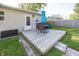 Backyard deck with an outdoor dining set, grassy lawn, and fenced in area for relaxing or entertaining at 540 Hanley St, Plainfield, IN 46168