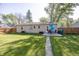 Spacious backyard featuring a deck, lush green grass, a sidewalk, and a wood fence at 540 Hanley St, Plainfield, IN 46168