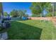 Large backyard with a wooden fence, deck, shed, swing set, and green lawn at 540 Hanley St, Plainfield, IN 46168