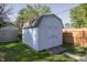 Backyard shed with a neutral color, a shingled roof, and green surroundings, adding to the landscape at 540 Hanley St, Plainfield, IN 46168