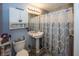 Compact bathroom with pedestal sink, toilet, and shower featuring a stylish patterned curtain at 540 Hanley St, Plainfield, IN 46168