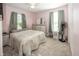 Calming bedroom with pink walls, neutral carpeting, and comfortable bed with decorative quilt at 540 Hanley St, Plainfield, IN 46168