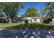 Charming single-story home with a well-manicured lawn and mature trees on a sunny day at 540 Hanley St, Plainfield, IN 46168