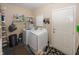 A clean laundry room featuring a washer, dryer, shelving, and convenient access to the exterior at 540 Hanley St, Plainfield, IN 46168