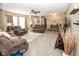 Open-concept living room filled with natural light, plush carpeting, and cozy brown reclining furniture at 540 Hanley St, Plainfield, IN 46168