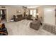Spacious living room with plush carpeting, ceiling fan, and comfortable brown reclining furniture at 540 Hanley St, Plainfield, IN 46168