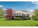 Lush backyard featuring a two-tiered deck with staircase and mature trees; an inviting space for outdoor entertainment at 542 Hadleigh Ct, Westfield, IN 46074