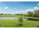 Scenic backyard view of a pond and landscaping, offering serene outdoor enjoyment with the beautiful flowering tree at 542 Hadleigh Ct, Westfield, IN 46074