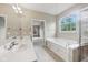 Bathroom featuring double sinks, soaking tub, and natural light at 542 Hadleigh Ct, Westfield, IN 46074
